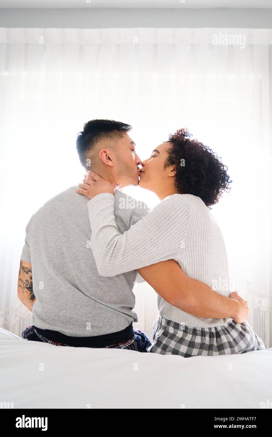 Romantic couple kissing in bed hi-res stock photography and images - Alamy