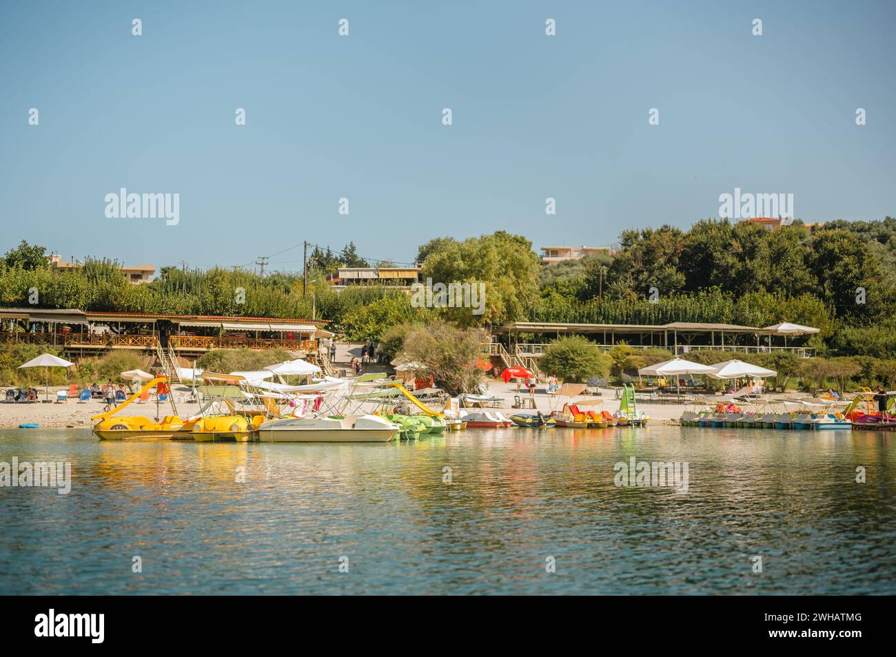 Restaurants and rental boats along Lake Kournas on the island of Crete Stock Photo