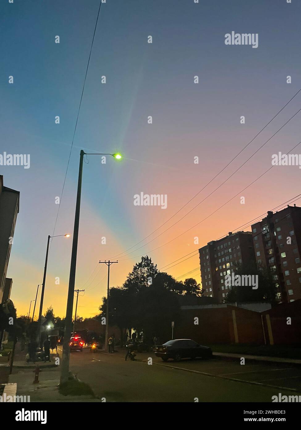 Cars parked on a city street at sunset Stock Photo - Alamy