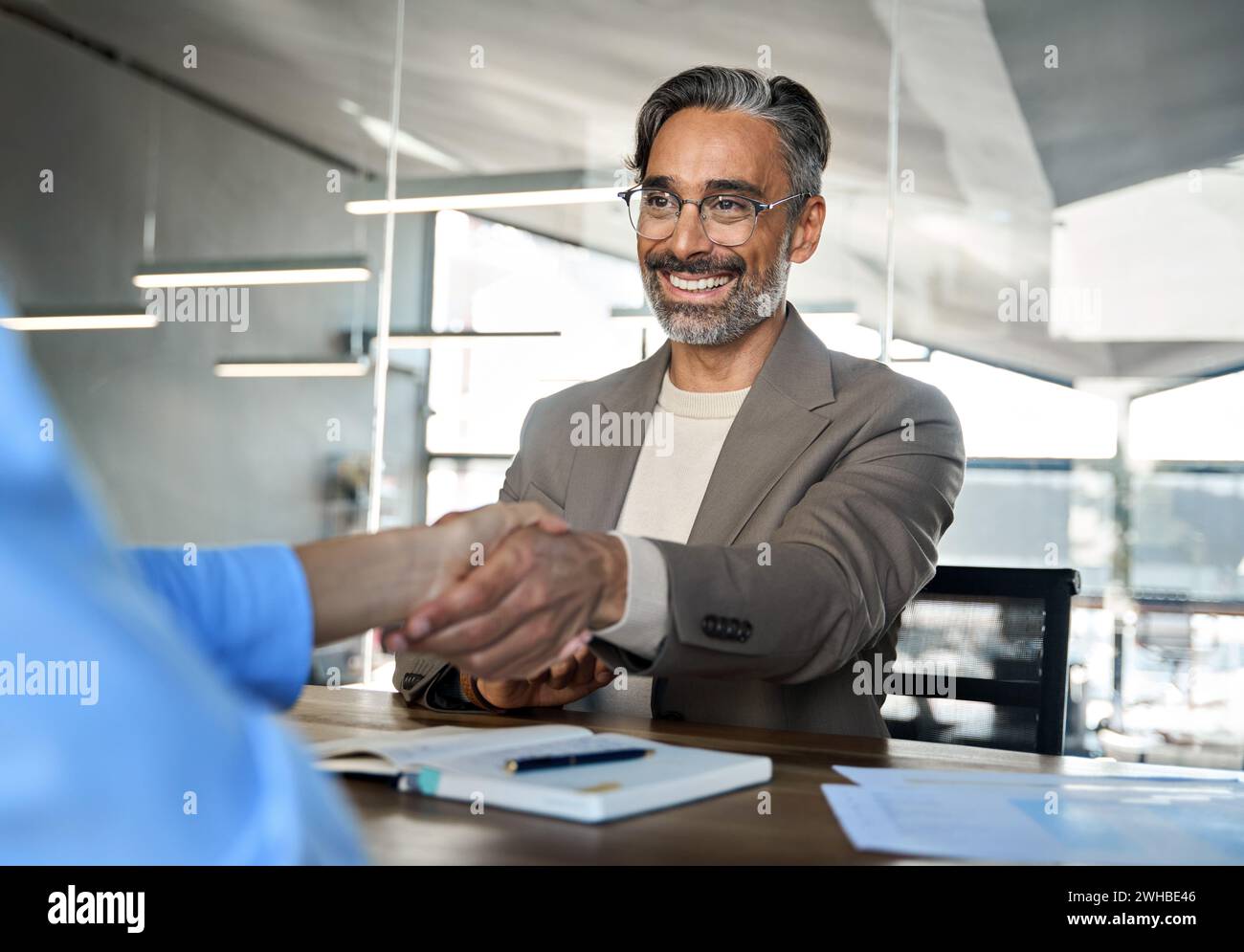 Happy mature business man manager and recruit handshake at job interview. Stock Photo