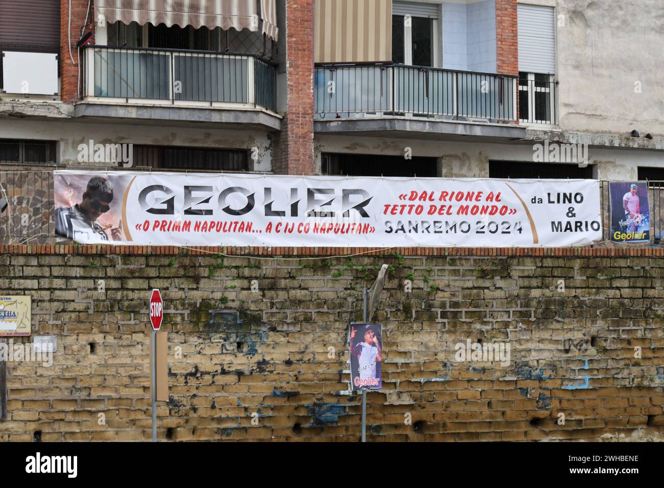 Among the people in the native neighborhood of rapper Geolier 02/09/2024 Naples, Gescal district in the northern outskirts of Naples where the family of the Neapolitan repper GEOLIER grew up and still lives. In the photo the posters in the streets where I objected and his fans await the arrival of him perhaps winner of the Saremo Festival 2024 NAPOLI RIONE Gescal miano CAMPANIA ITALIA Copyright: xFABIOxSASSOxFabioxSassox IMG 3229 Stock Photo