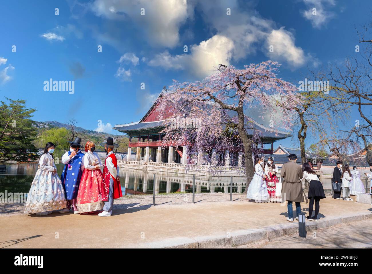 Korean couple with Korean traditional dress Hanbok in Gyeongbokgung palace in spring, seoul, south korea. Stock Photo