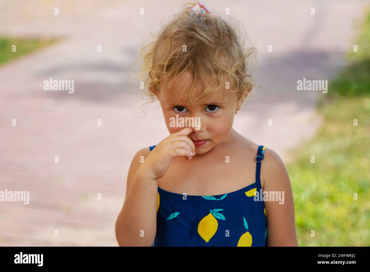 The child picks his nose. Selective focus. Stock Photo