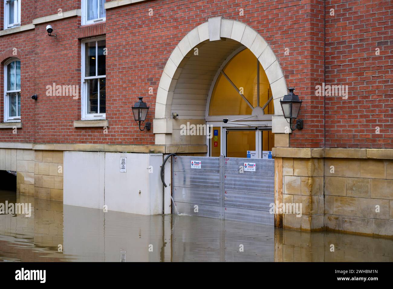 River Ouse burst its banks after heavy rain (riverside submerged, high water, premises flooded, door exterior) - York, North Yorkshire, England, UK. Stock Photo