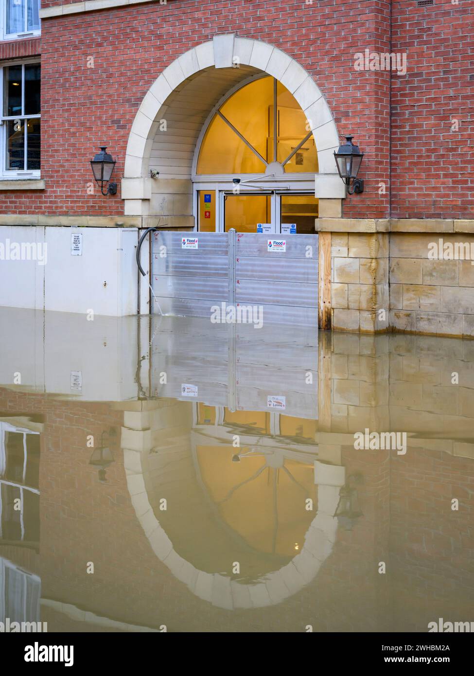 River Ouse burst its banks after heavy rain (riverside submerged, high water, premises flooded, door exterior) - York, North Yorkshire, England, UK. Stock Photo
