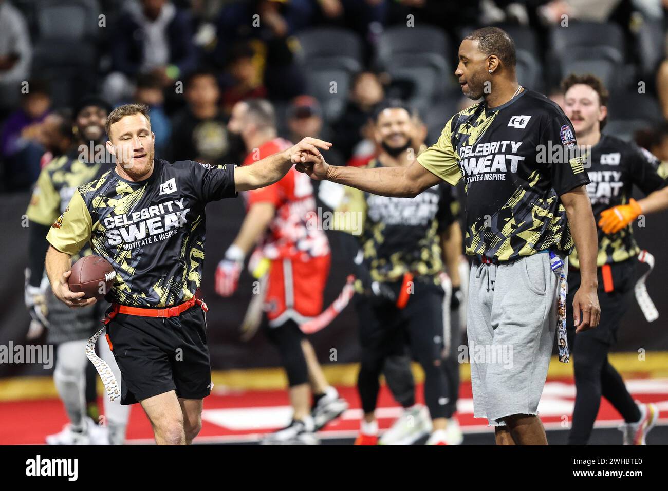 February 08, 2024: (L-R) UFC fighter Justin Gaethje celebrates a score with Retired NBA player Tracy McGrady during the 24th annual Celebrity Flag Football Challenge at the Dollar Loan Center in Henderson, NV. Christopher Trim/CSM. Stock Photo