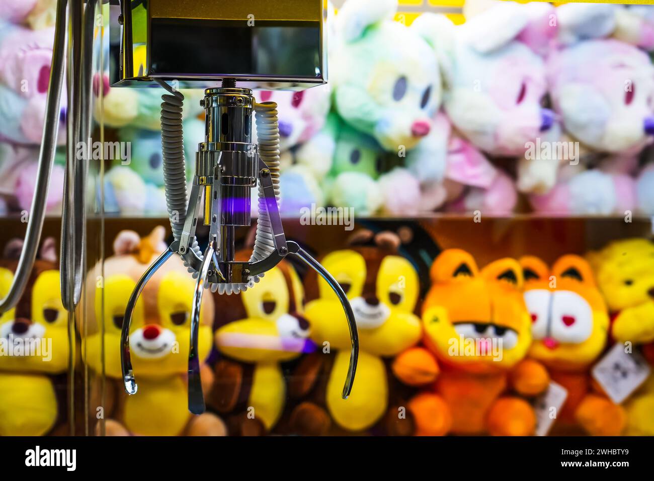 Toy crane vending machine, claw game or to catch the toys. Shopping, holiday activity