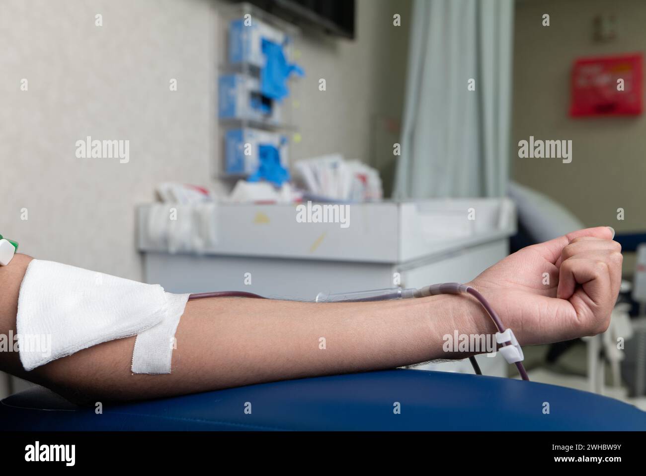 A Person In Gloves Putting A Needle On A Mannequin. Stock Photo