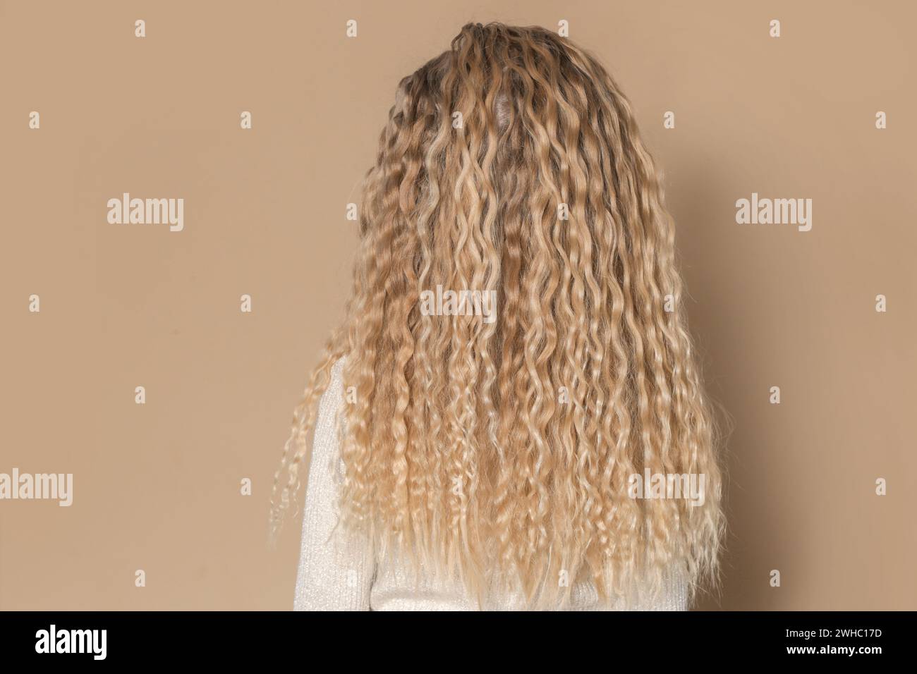 Back view of little girl with blonde curly long hair Stock Photo