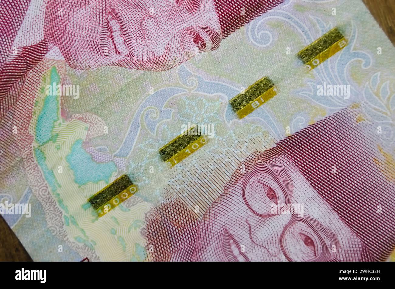 Macro photography of Rp.100.000 banknote. Close-up view of Indonesian one hundred thousand rupiah banknote with security thread. Rupiah is the officia Stock Photo
