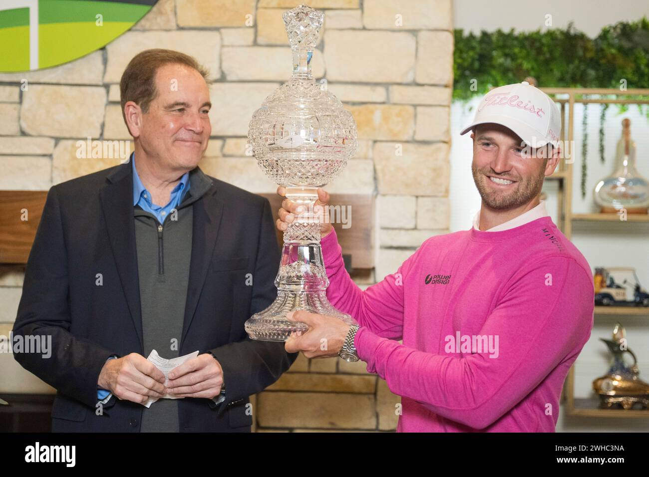 Wyndham Clark is presented with the trophy after winning the AT&T
