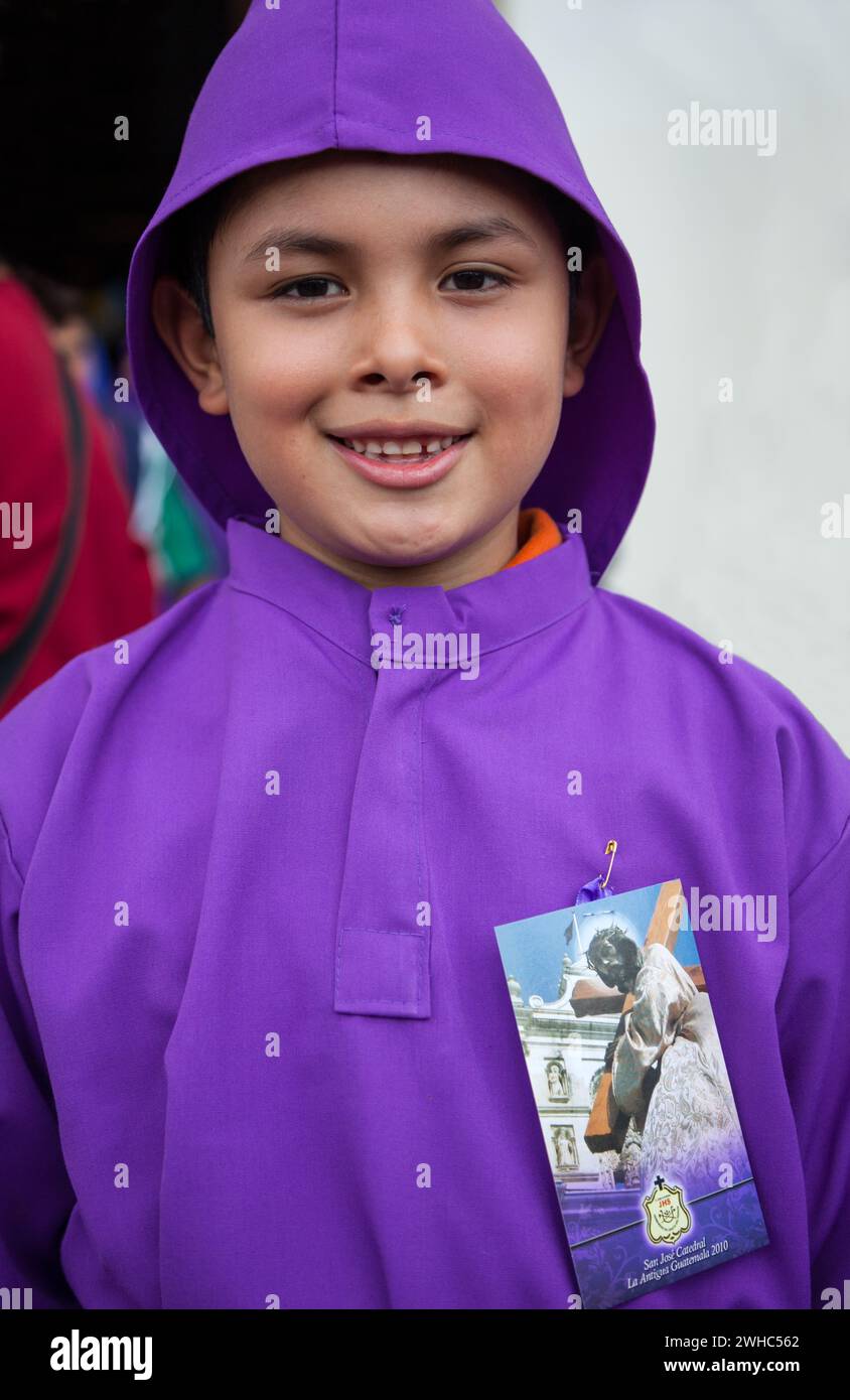 Antigua, Guatemala.  Young Boy Dressed as Novice Cucurucho, Semana Santa. Stock Photo