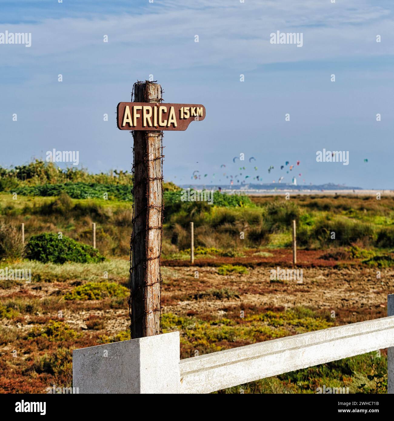 Signpost, distance to Africa 15 km, kitesurfer on the horizon, Tarifa, Cadiz, Andalusia, Spain Stock Photo
