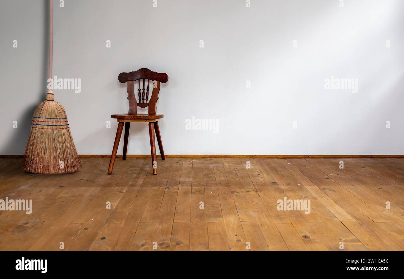 Brushwood broom on a wooden floor in an interior room Stock Photo