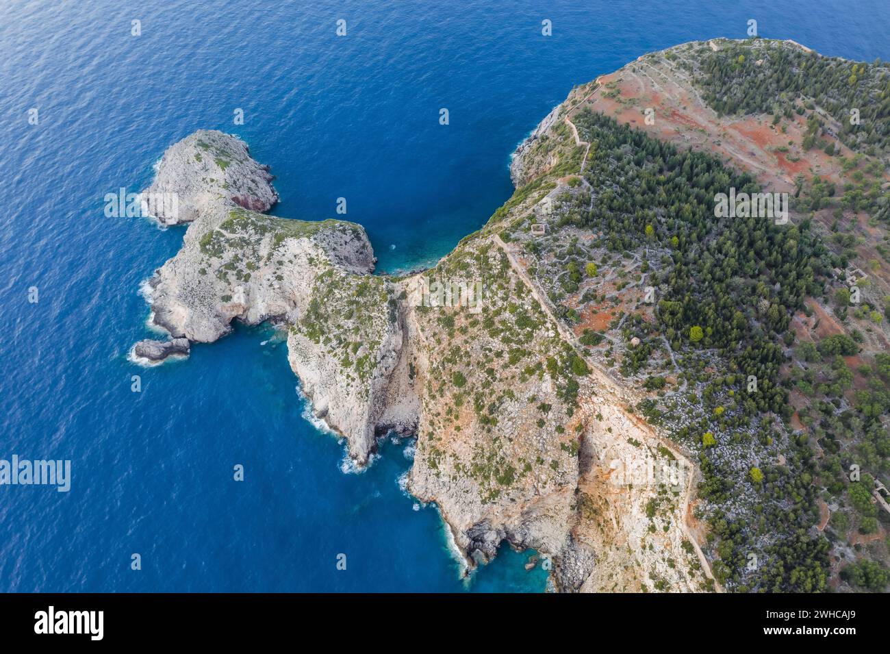 Aerial view of Assos peninsula and fantastic turquoise and blue Ionian Sea water. Top view, summer scenery of famous and extremely popular travel destination in Cephalonia, Greece. Stock Photo