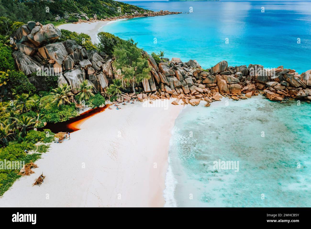 Aerial top view of Seychelles tropical paradise beach with crystal clear turquoise water and bizarre granite rocks. La Digue Island. Stock Photo
