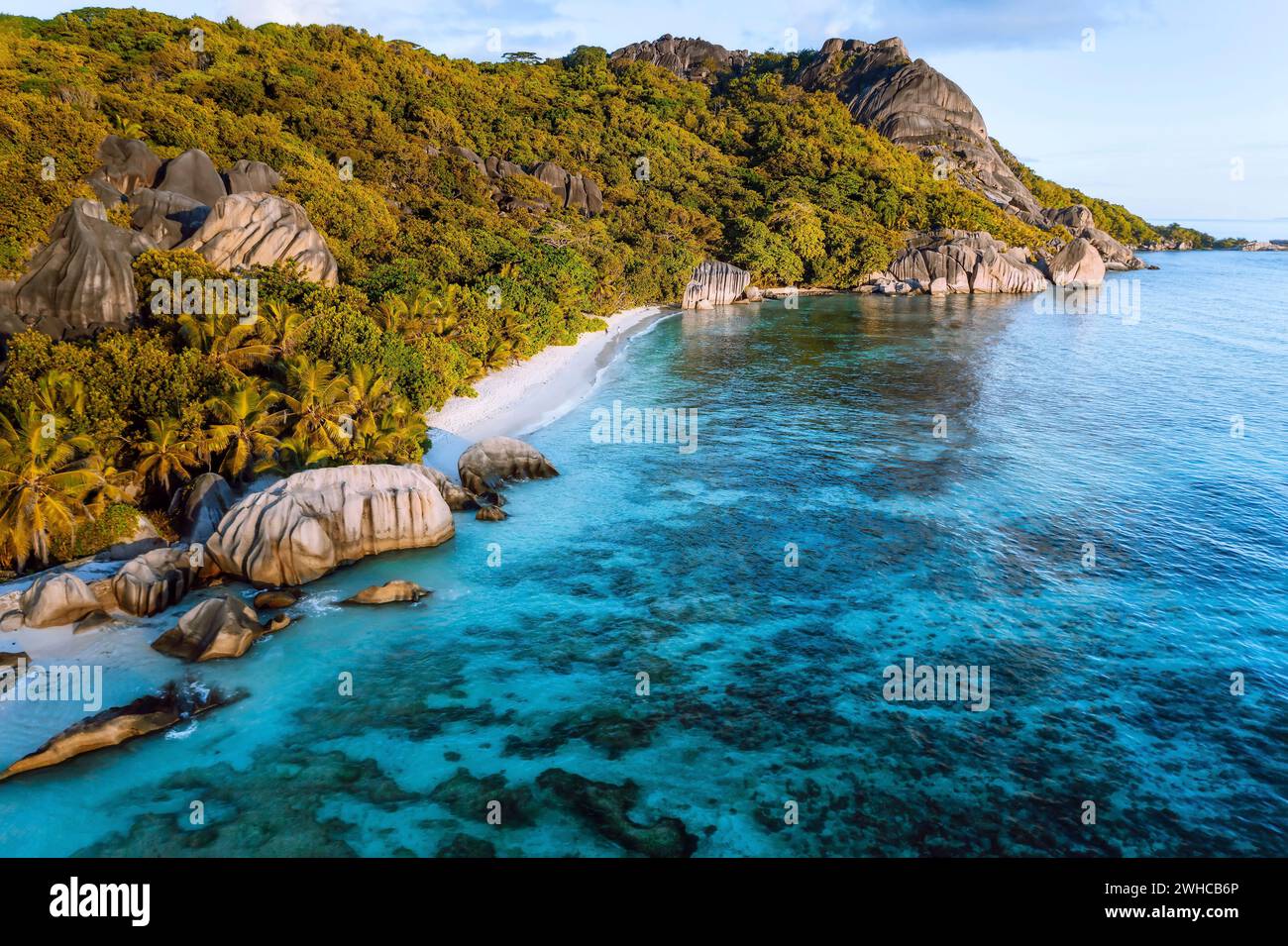 Golden hour at Anse Source D Argent exotic beach at Seychelles. Aerial drone photo from above. Stock Photo