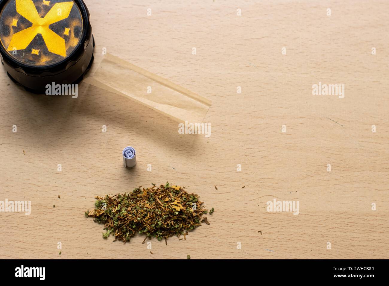 Preparing a joint and drug paraphernalia concept theme with herb girder