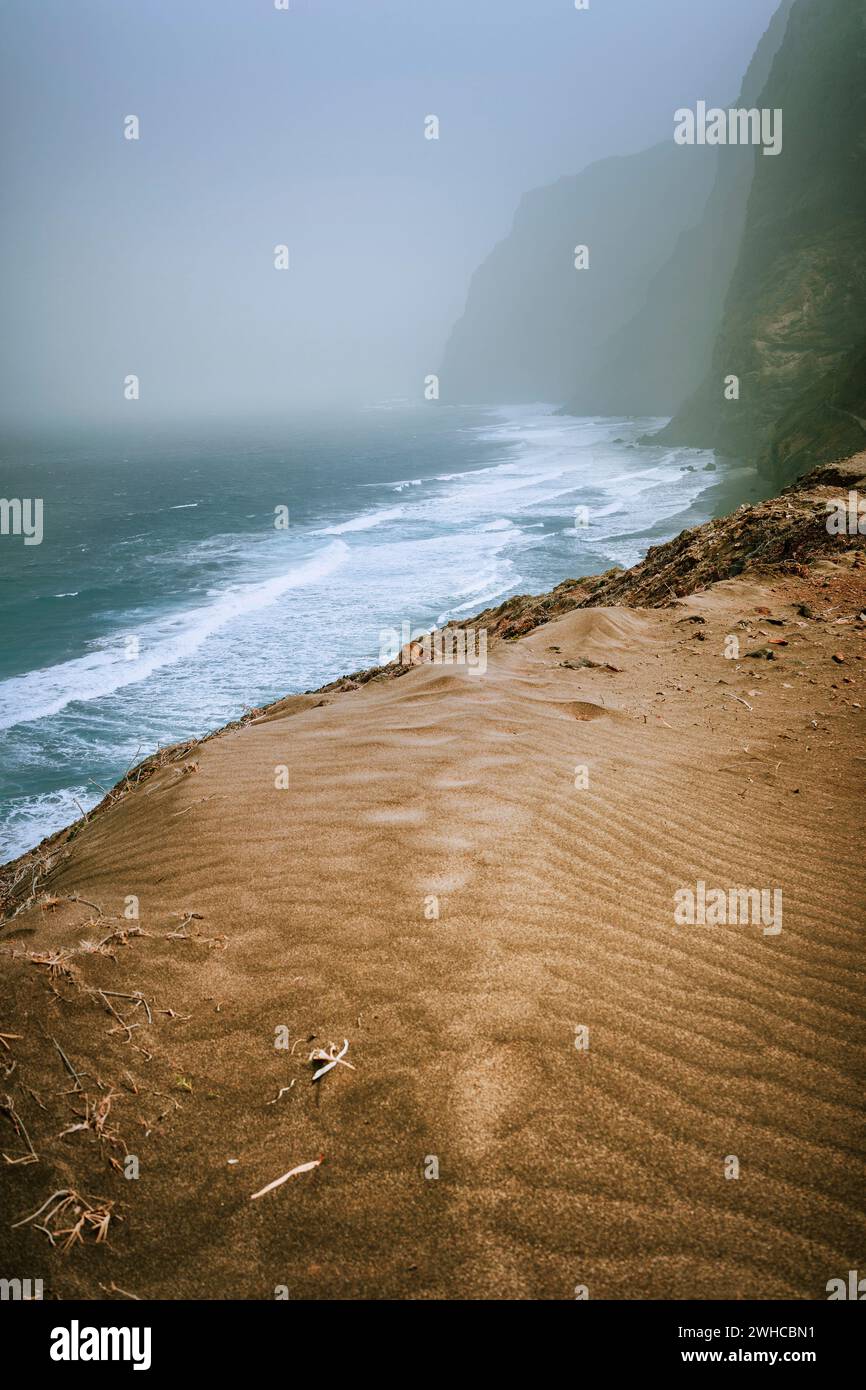 Santo Antao, Cape Verde - Sand dune on the hike trail from Cruzinha da Garca to Ponta do Sol. Moody Atlantic coastline with ocean waves. Stock Photo