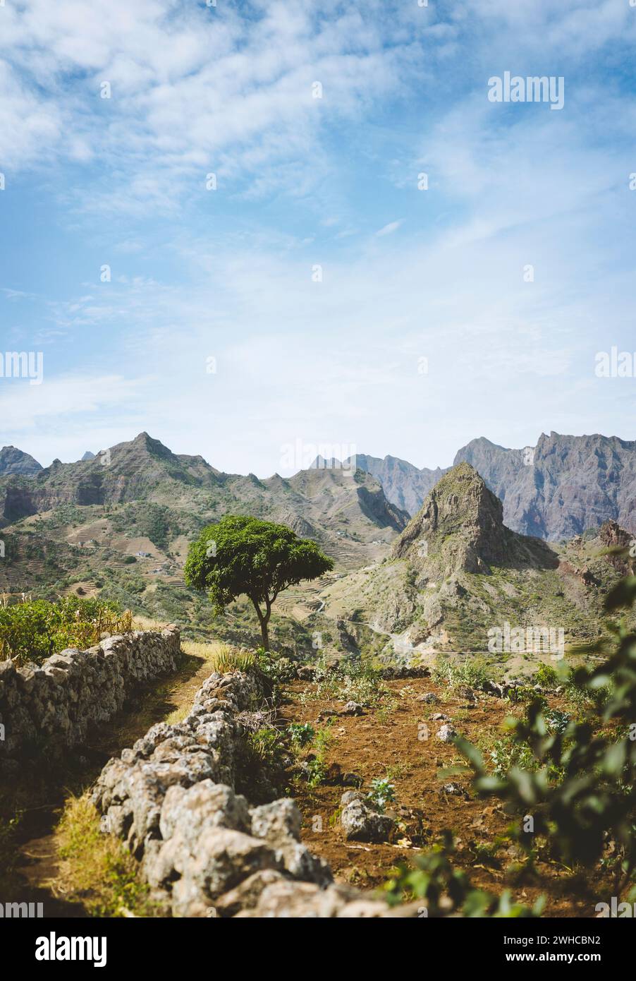 Hiking trail leading through arid rocky terrain towards Coculli village on Santo Antao Cape Verde. Stock Photo