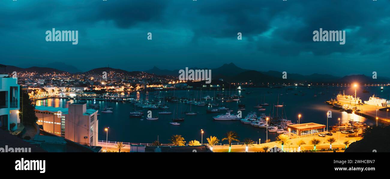 Cape Verde, Sao Vicente Island. Twilight panoramic view of Mindelo city port town with many boats in the lagoon. Stock Photo