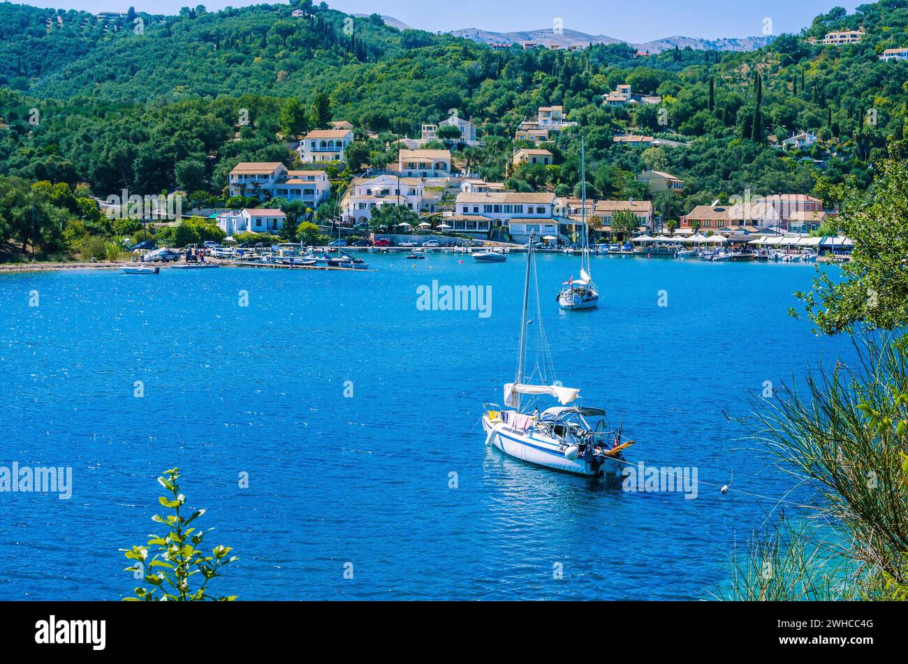 Yacht at anchor in front of Agios Stefanos, Corfu, Greece. Stock Photo