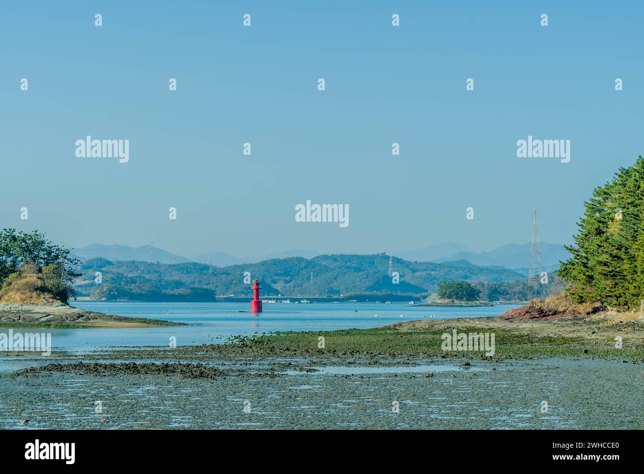 Red channel marker beacon between two islets at low tide in South Korea