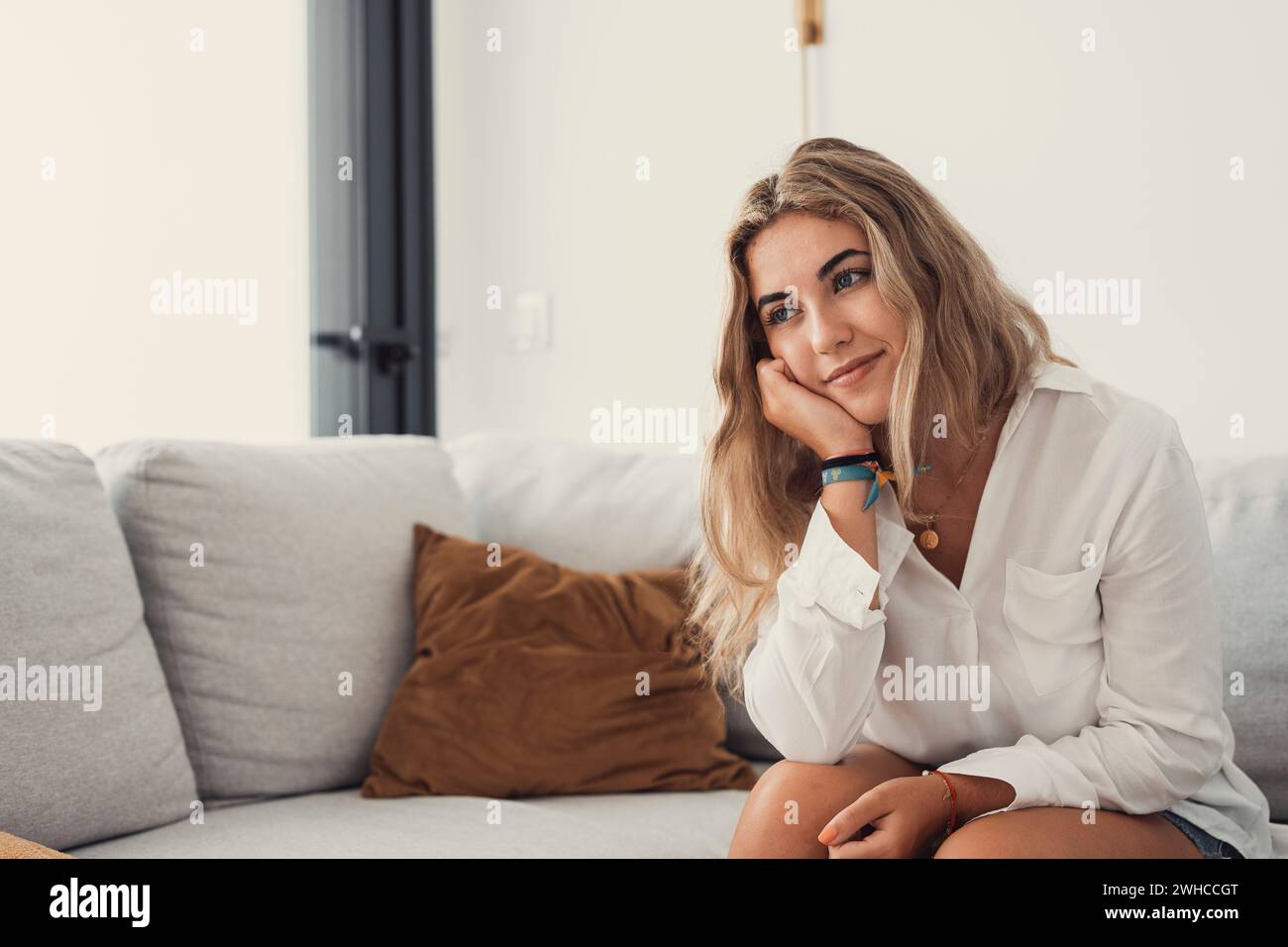 Happy young woman look in distance feeling positive and optimistic, dream or visualizing of new beginning, smiling millennial girl thinking overjoyed excited for future, happiness, good mood concept Stock Photo