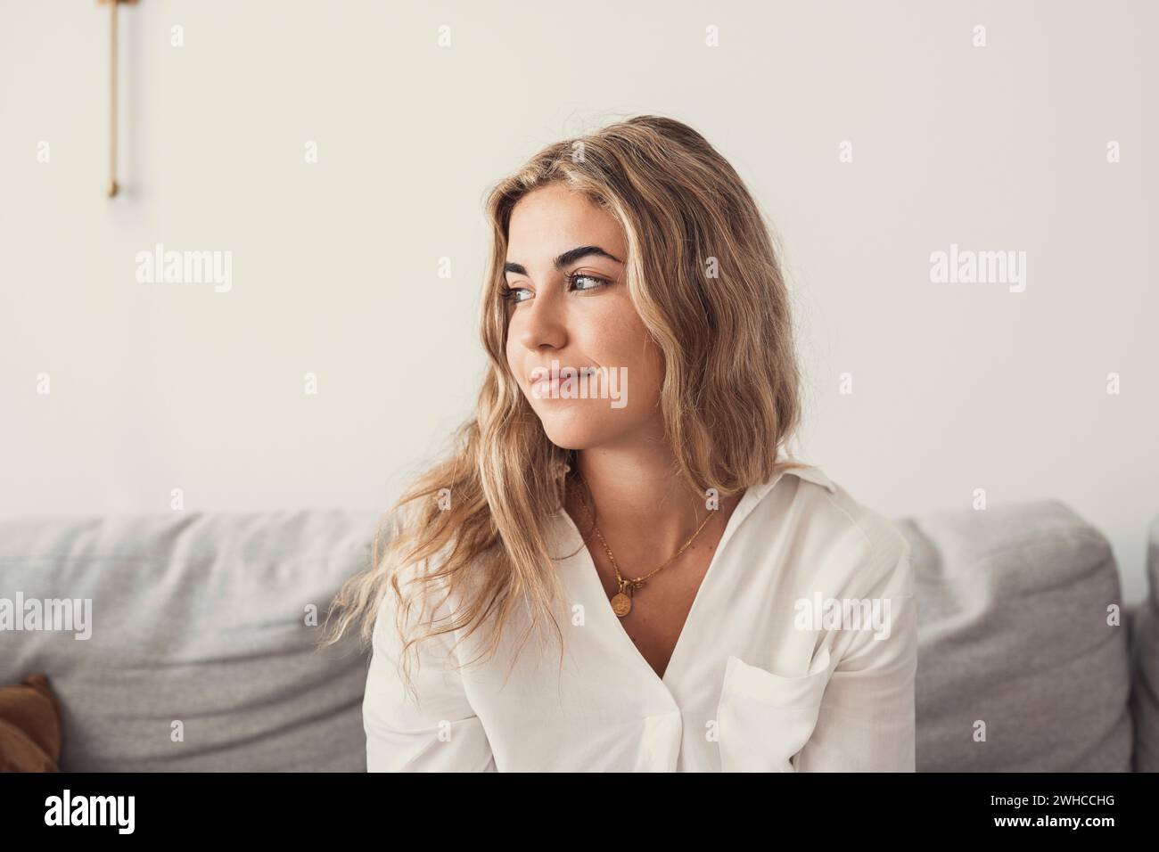 Happy young woman look in distance feeling positive and optimistic, dream or visualizing of new beginning, smiling millennial girl thinking overjoyed excited for future, happiness, good mood concept Stock Photo