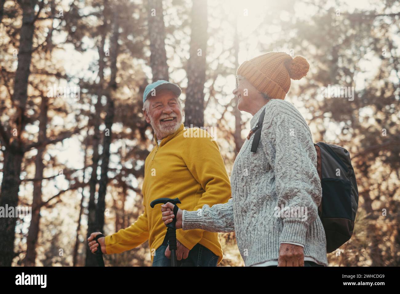 Portrait close up head shot of one cheerful smiling middle age woman walking with her husband enjoying free time and nature. Active beautiful seniors in love together at sunny day. Stock Photo