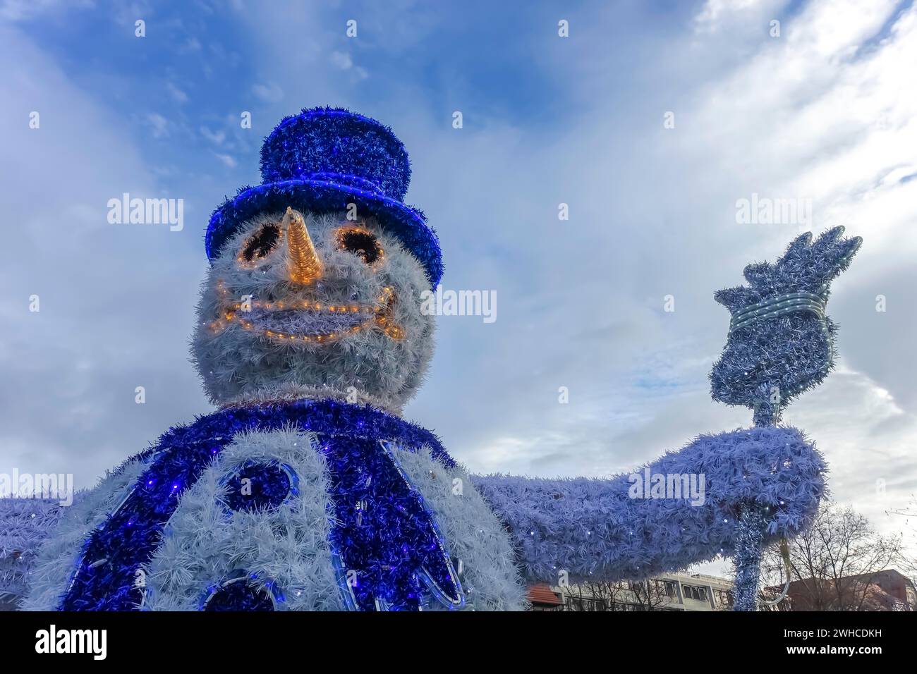Snowman with hat, carrot nose, broom, top hat, scarf, illuminated figurine, mouth, eyes, funny winter motif, Christmas motif, Christmas, Christfest Stock Photo