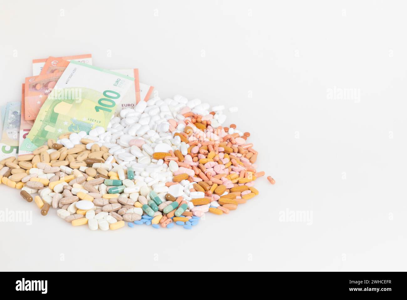 Piles of pills and banknotes on a white background, copy room Stock ...