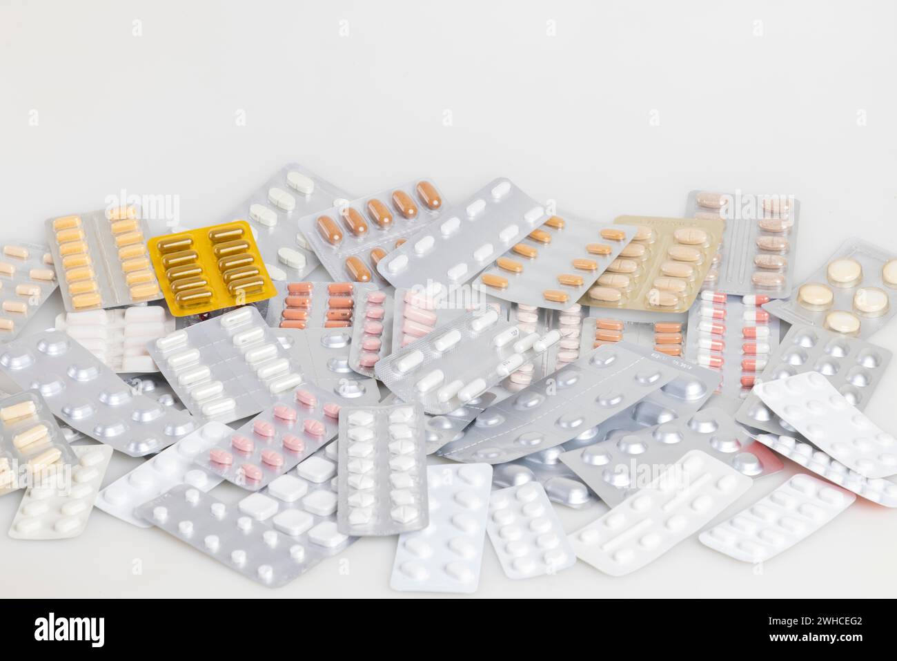 A collection of different medicines in blister packs on a light-coloured background Stock Photo