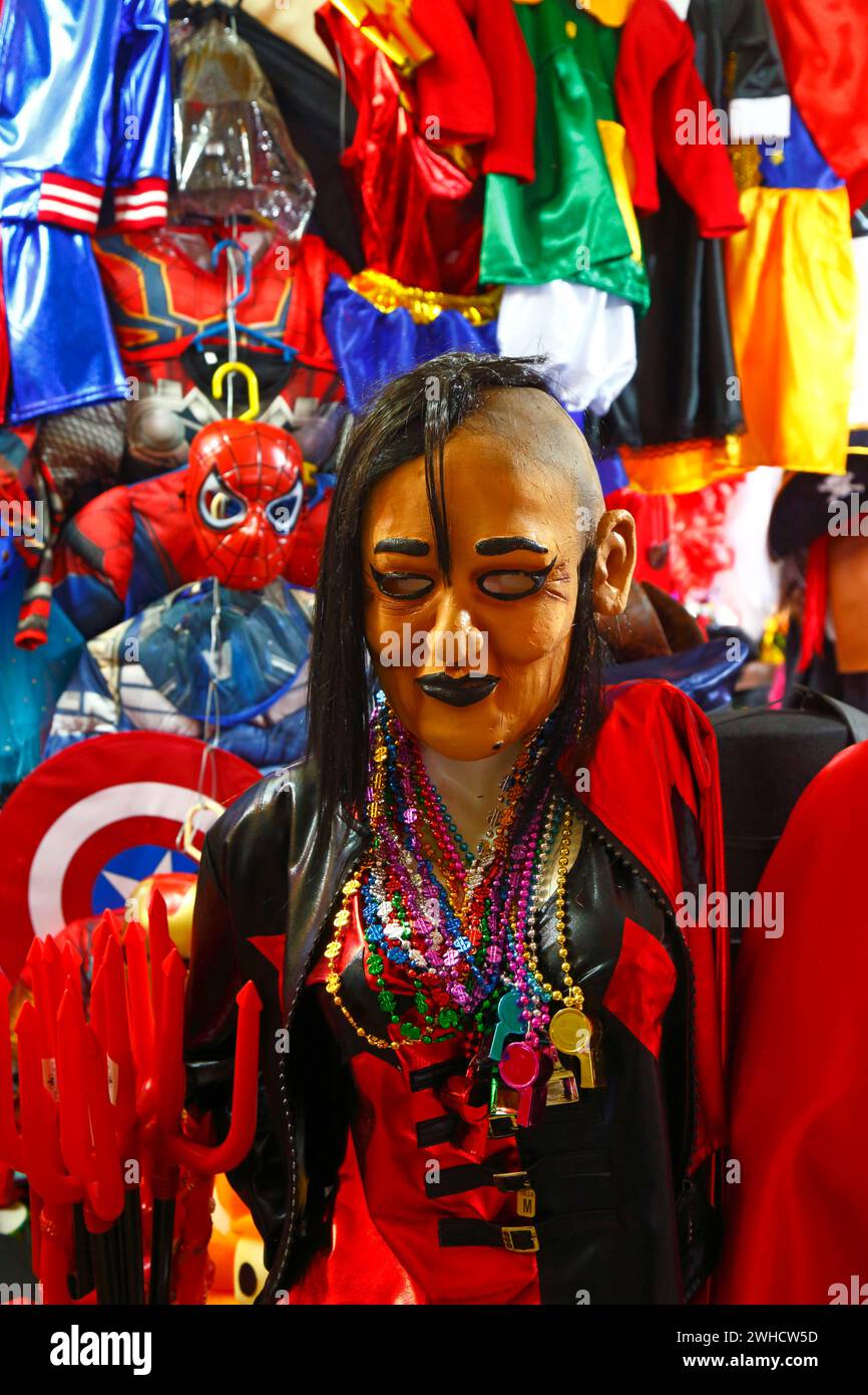 La Paz, BOLIVIA; February 9th 2024: A rubber mask showing María Galindo Neder, leader of the Bolivian feminism collective Mujeres Creando, for sale on a stall selling masks and costumes for Carnival, which takes place this weekend. María Galindo is a well known radical feminist in Bolivia who also works as a radio presenter. Mujeres Creando are heavily involved in campaigns against violence against women, promoting women's rights and other social issues, defending women. Stalls selling Carnival costumes often sell masks that are caricatures of politicians and public figures as well as more typ Stock Photo