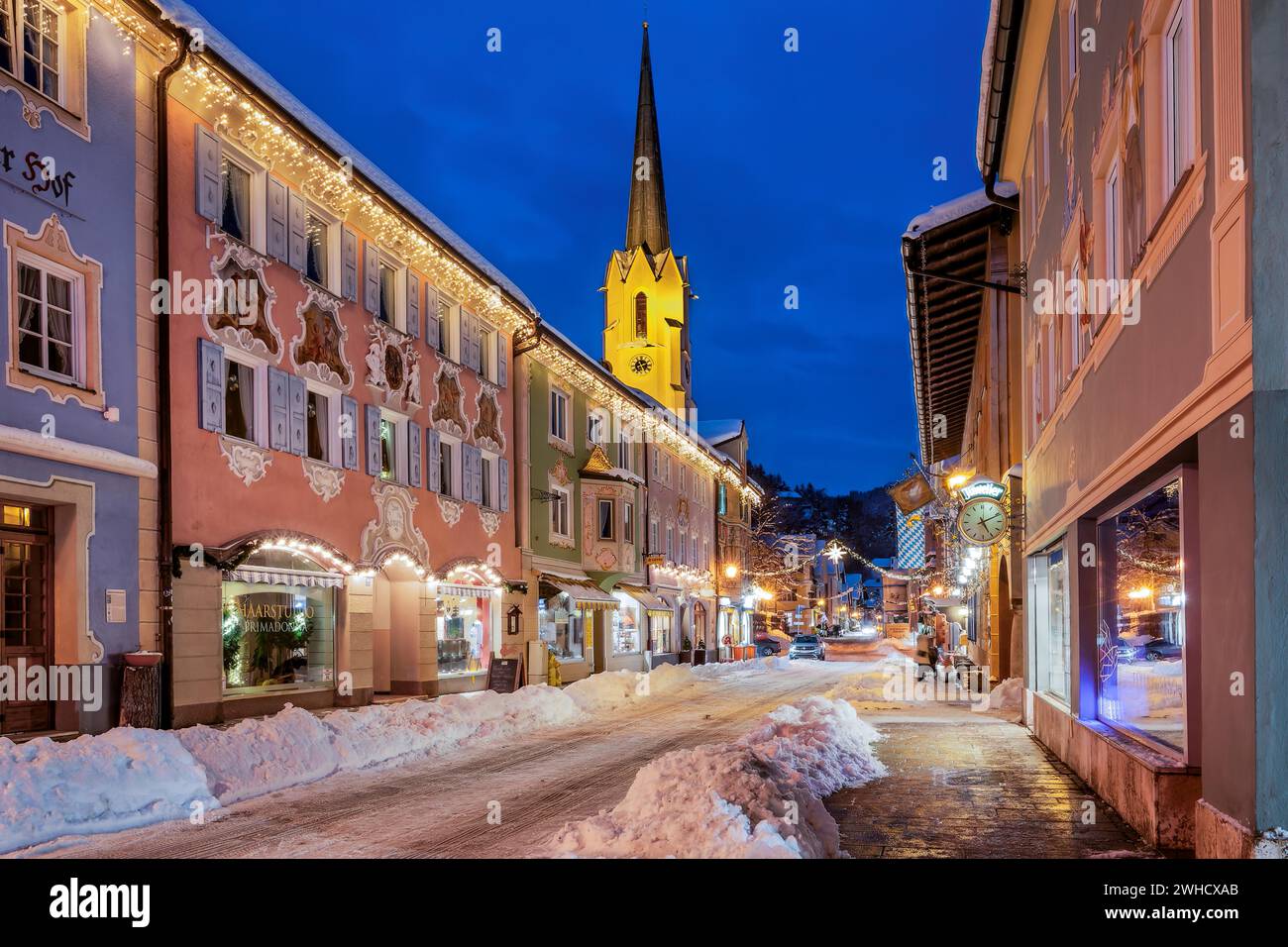 Snow-covered historic Ludwigstrasse in the Partenkirchen district with Christmas lights at dusk, Garmisch-Partenkirchen, Loisachtal, Werdenfelser Stock Photo