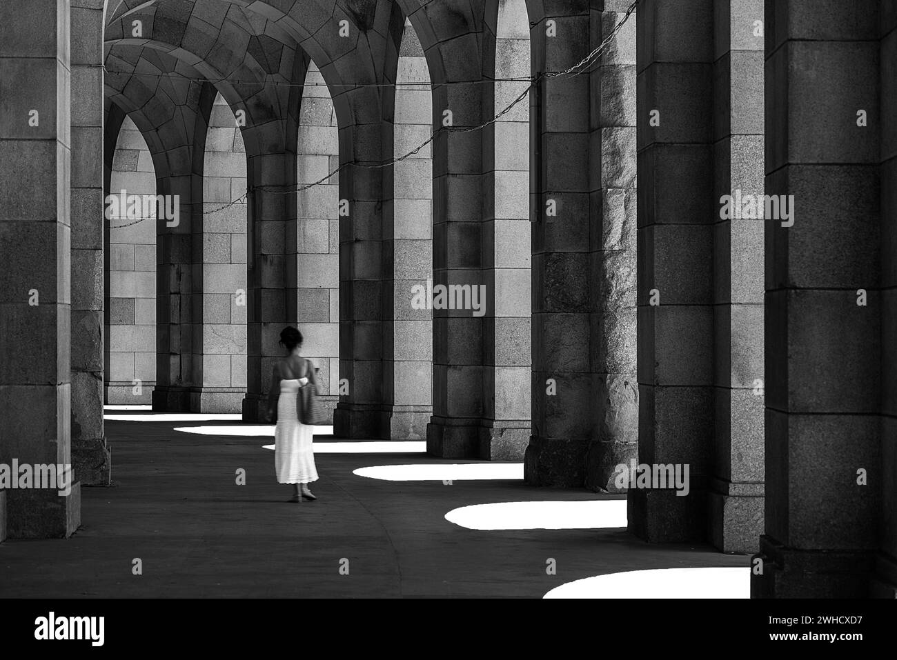 Lady in a white dress in the arcade of the Congress Hall, unfinished National Socialist monumental building on the Nazi Party Rally Grounds Stock Photo