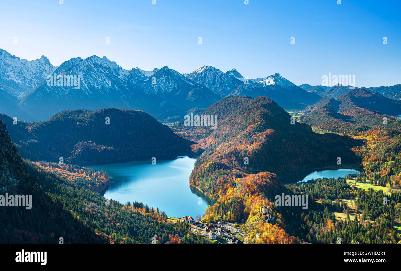 Mountain landscape near Hohenschwangau on a sunny fall day. Forests, lakes and snow-covered mountains. View from Tegelberg to Alpsee, Schwansee and Allgäu Alps. Bavaria, Germany, Europe Stock Photo