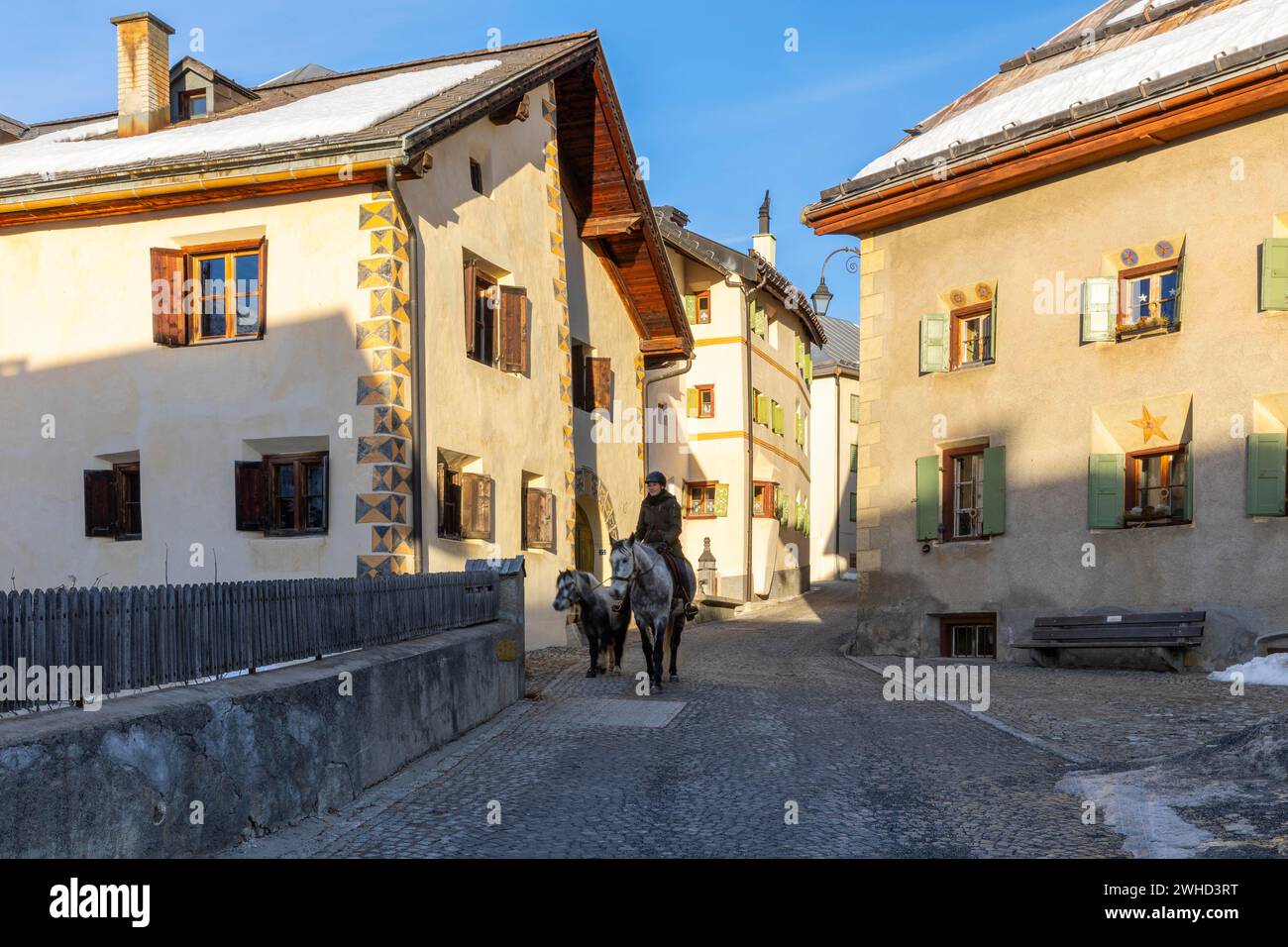 Horsewoman on horseback, historic houses, sgraffito, facade decorations, historic village, Guarda, Engadin, Grisons, Switzerland Stock Photo