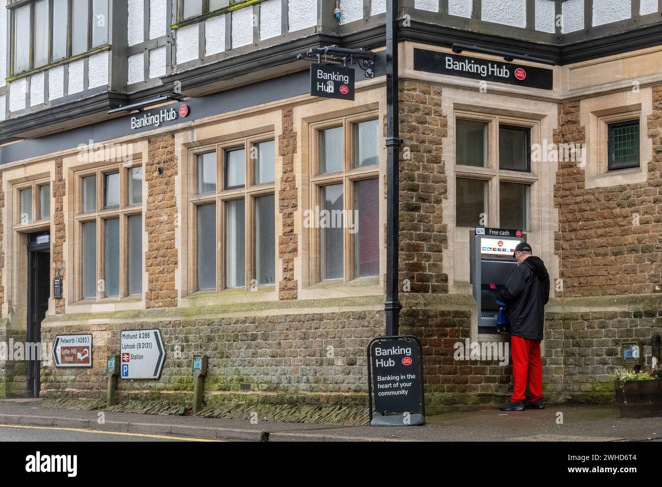 Banking hub run by post office in Haslemere town, Surrey, England, UK. Hubs are shared spaces on the high street serving customers of multiple banks. Stock Photo
