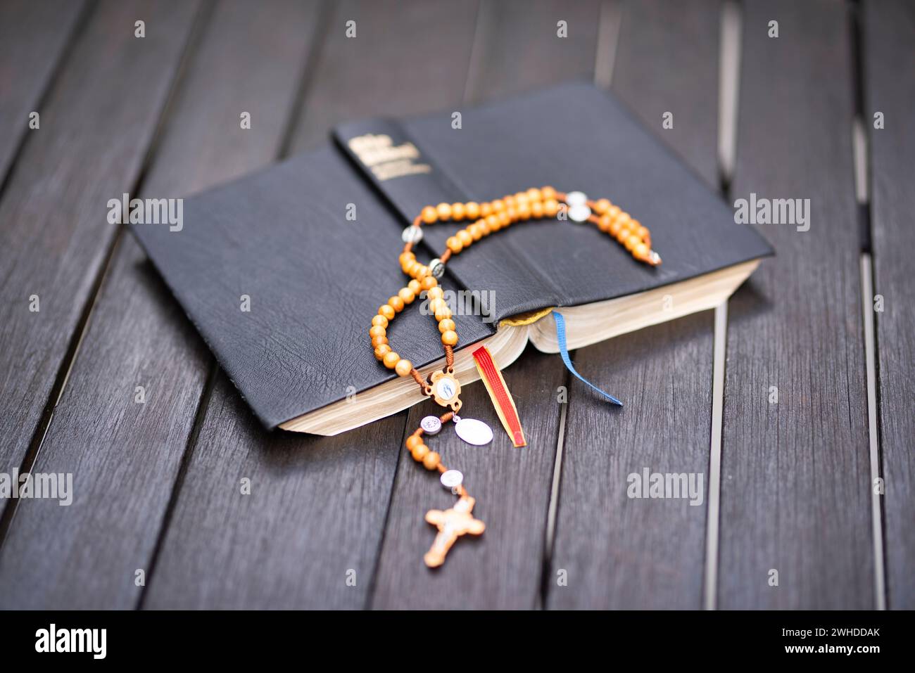 Bible standard translation with olive wood rosary hires stock