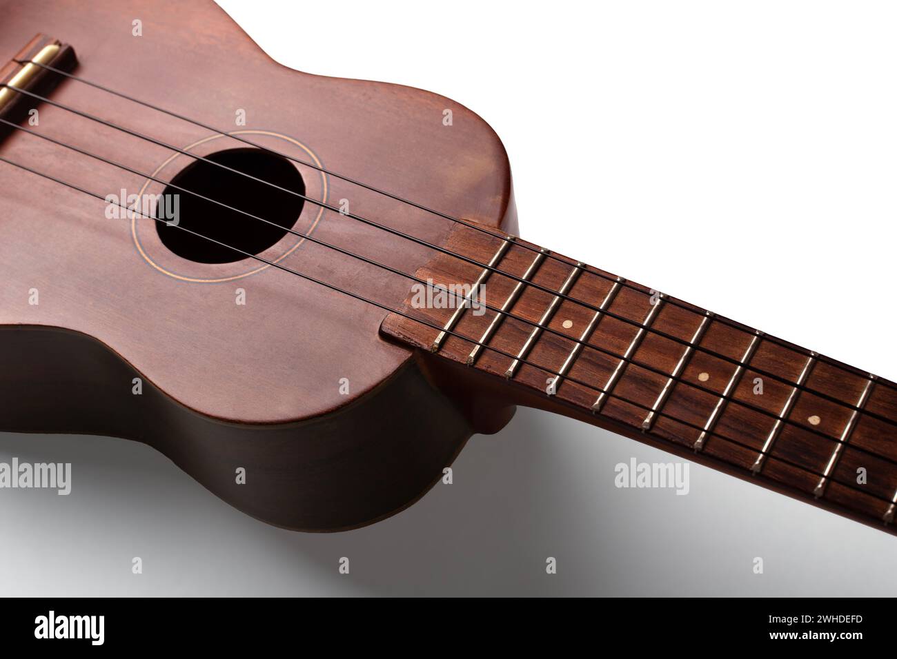 Vintage Ukulele Musical Instrument Close Up Angles Strings Body Soundhole Bridge Brown Dark Wood White Background Stock Photo