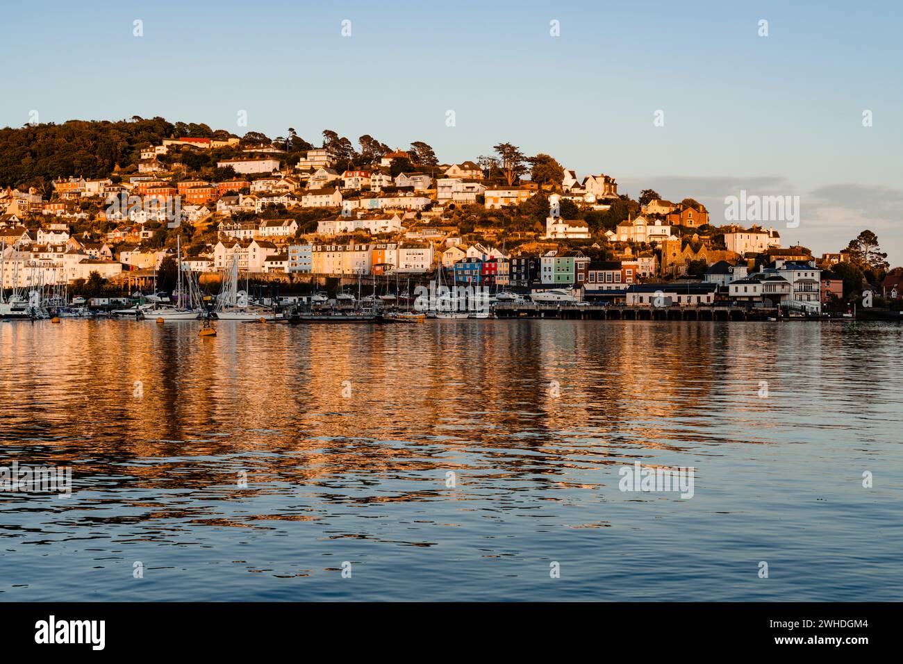 Evening atmosphere in the bay of the harbor town of Dartmouth, view of the town's houses reflected in the water Stock Photo