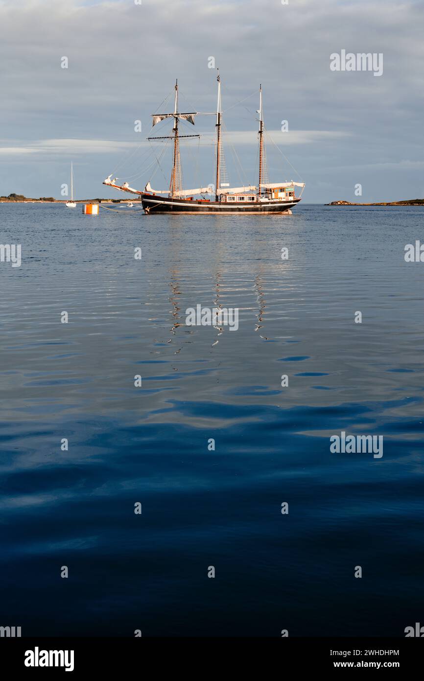 A three-master is anchored off the French west coast in Brittany, view of the sea, vacation atmosphere Stock Photo