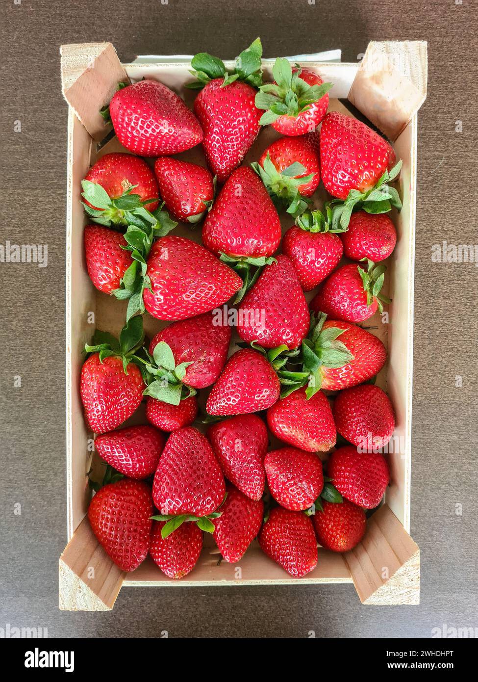 Whole fresh ripe red strawberries in a box Stock Photo