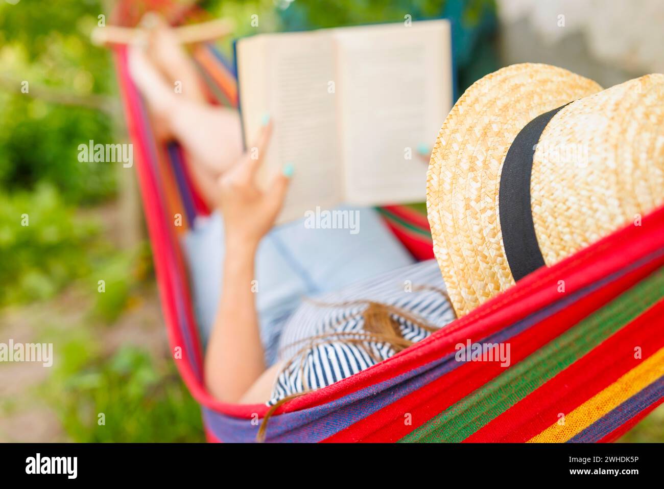 Relaxing Summer Reading in a Hammock Stock Photo