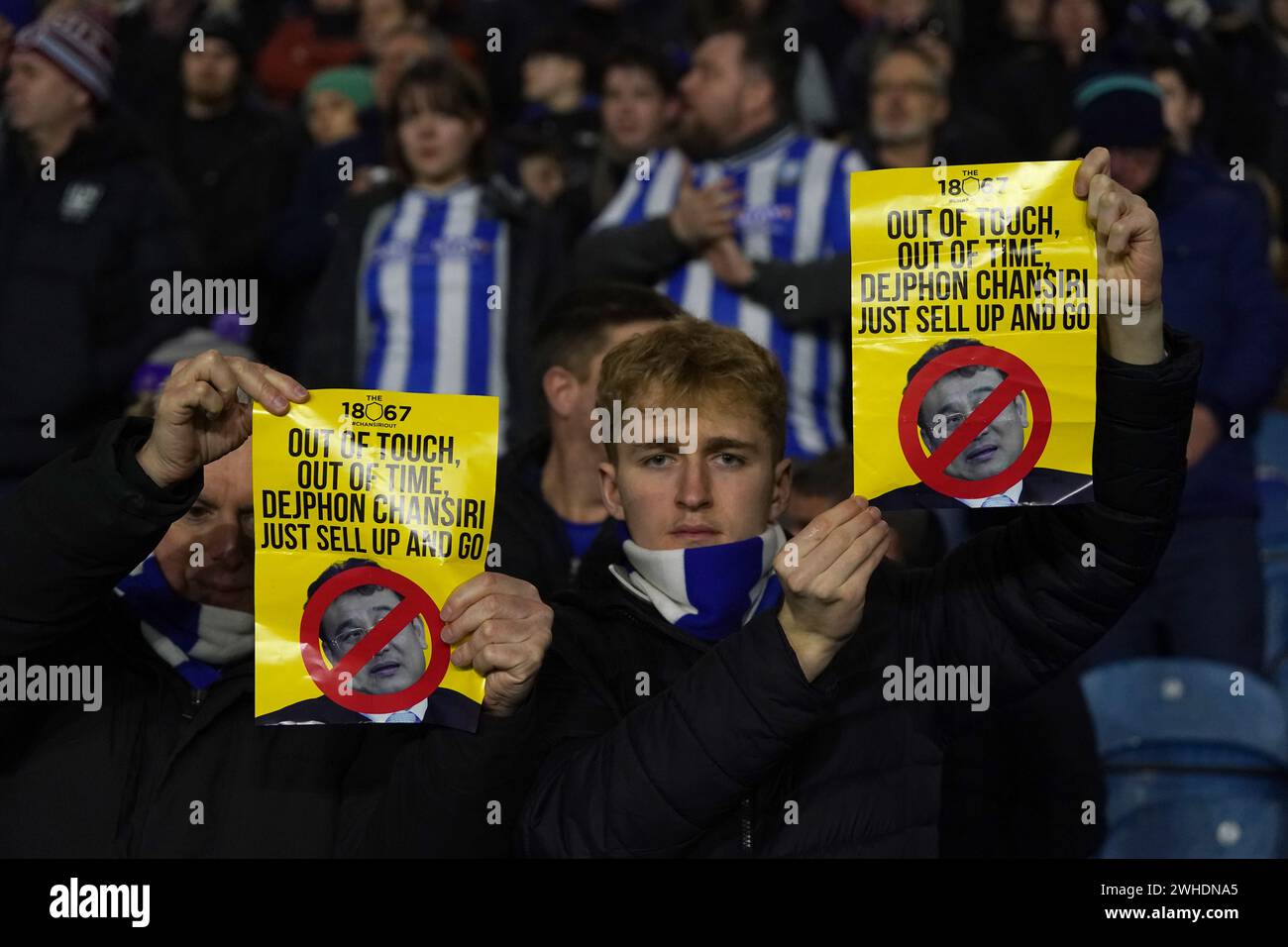 Sheffield Wednesday fans hold signs in protest at the club's owner Dejphon Chansiri before the Sky Bet Championship match at Hillsborough, Sheffield. Picture date: Friday February 9, 2024. Stock Photo