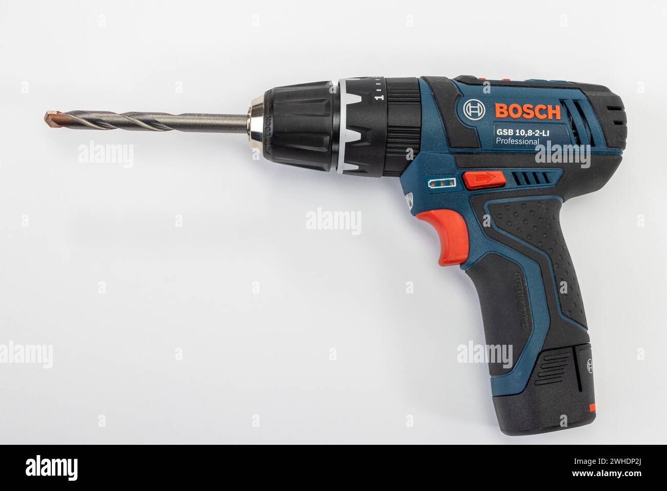 Cordless drill from Bosch, with inserted masonry drill bit, white background, Stock Photo