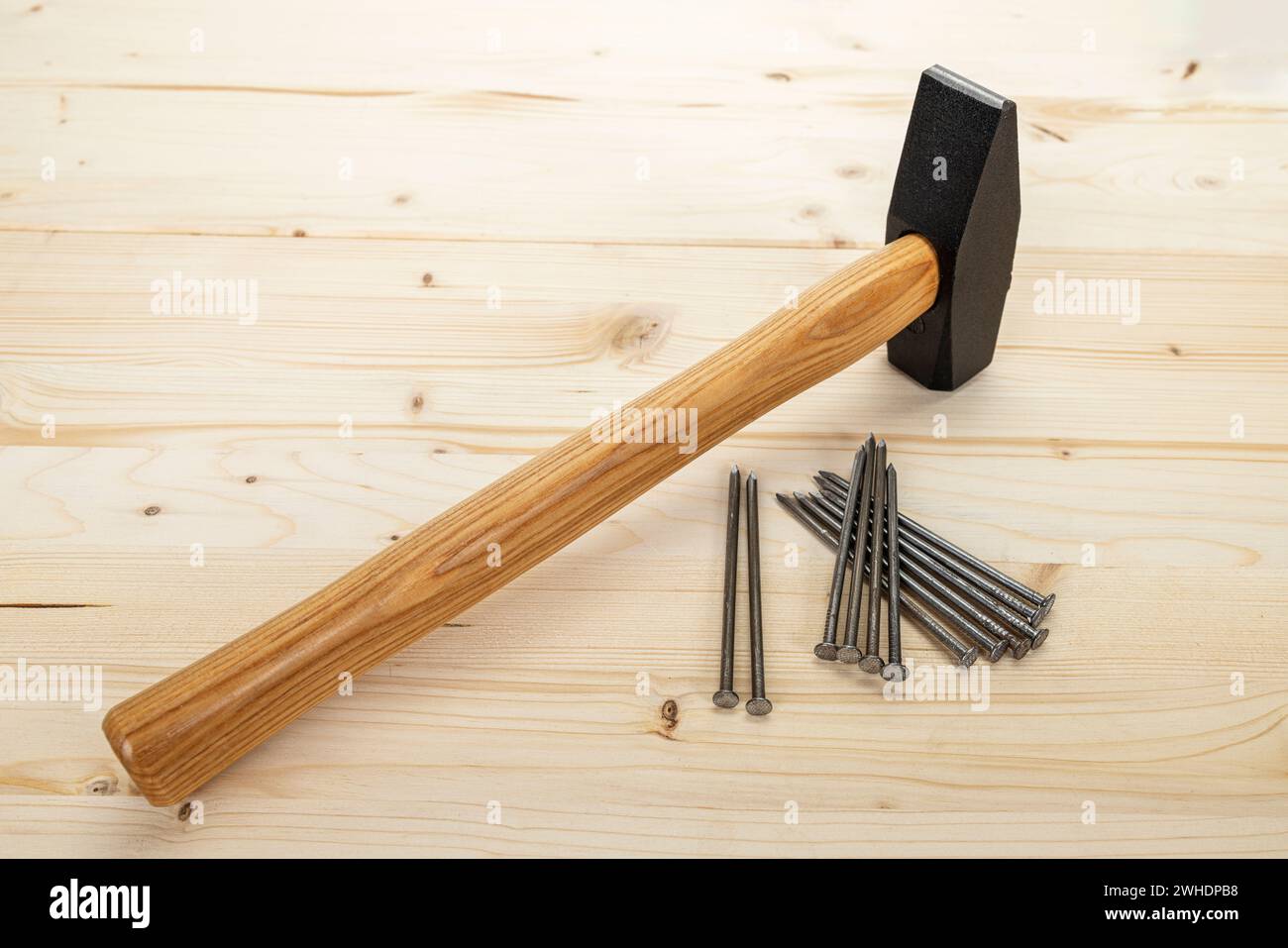 Locksmith's hammer, steel nails, wood Background, Stock Photo