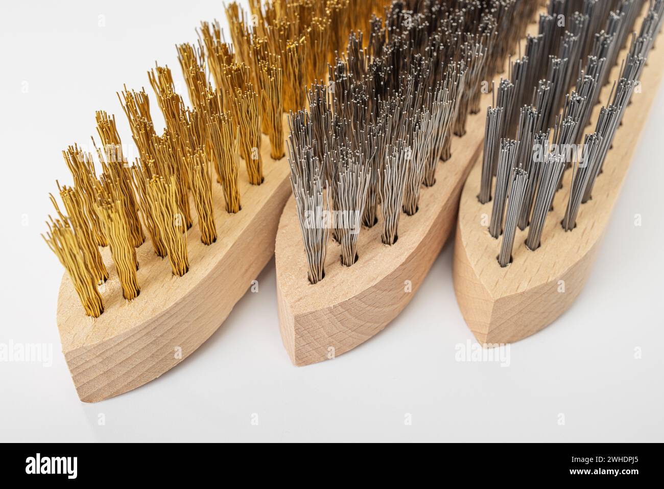 Three hand wire brushes with wooden handle, brass brush, stainless