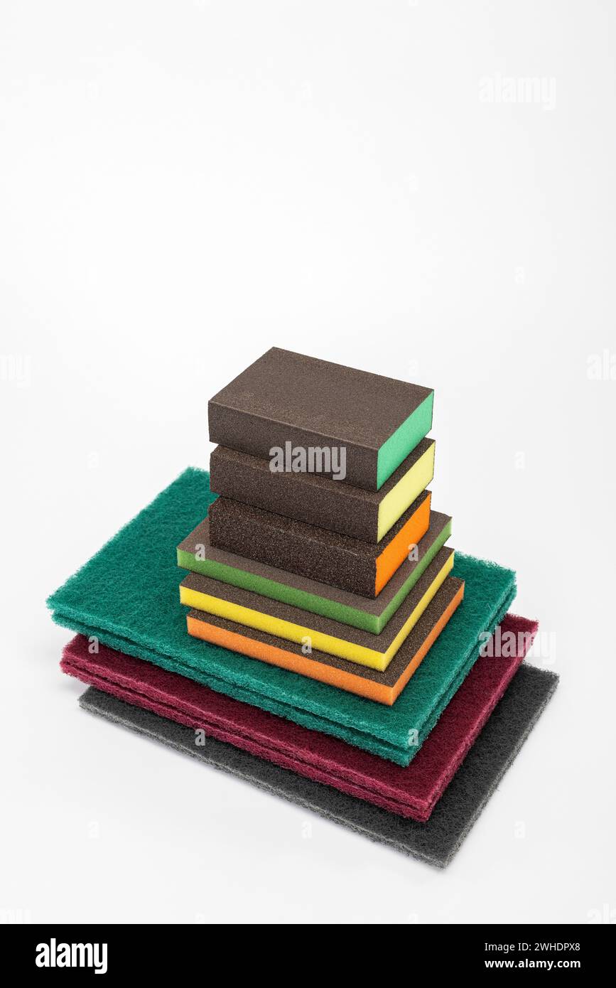 Various sanding sponges, sanding fleece, sizes, grits, structures, colors, white background, Stock Photo